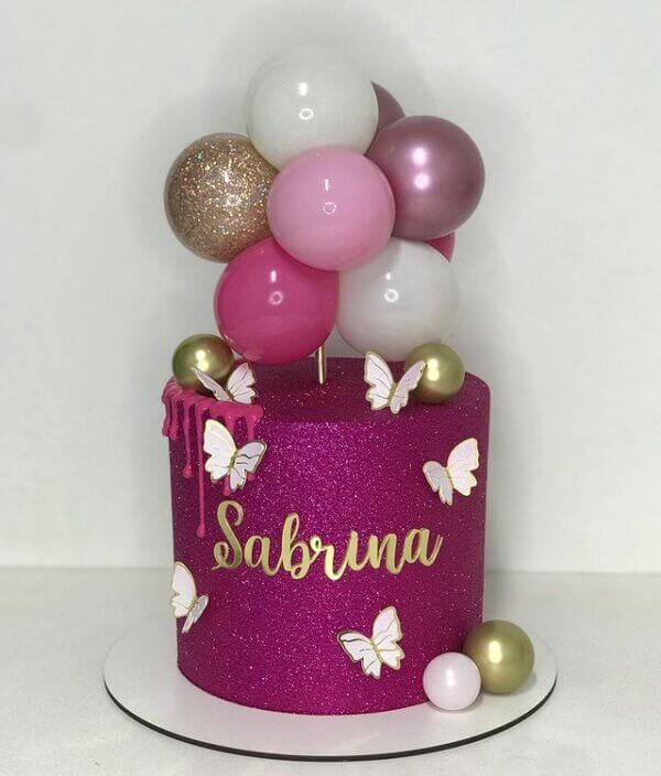 Bolo de batizado rosa e dourado