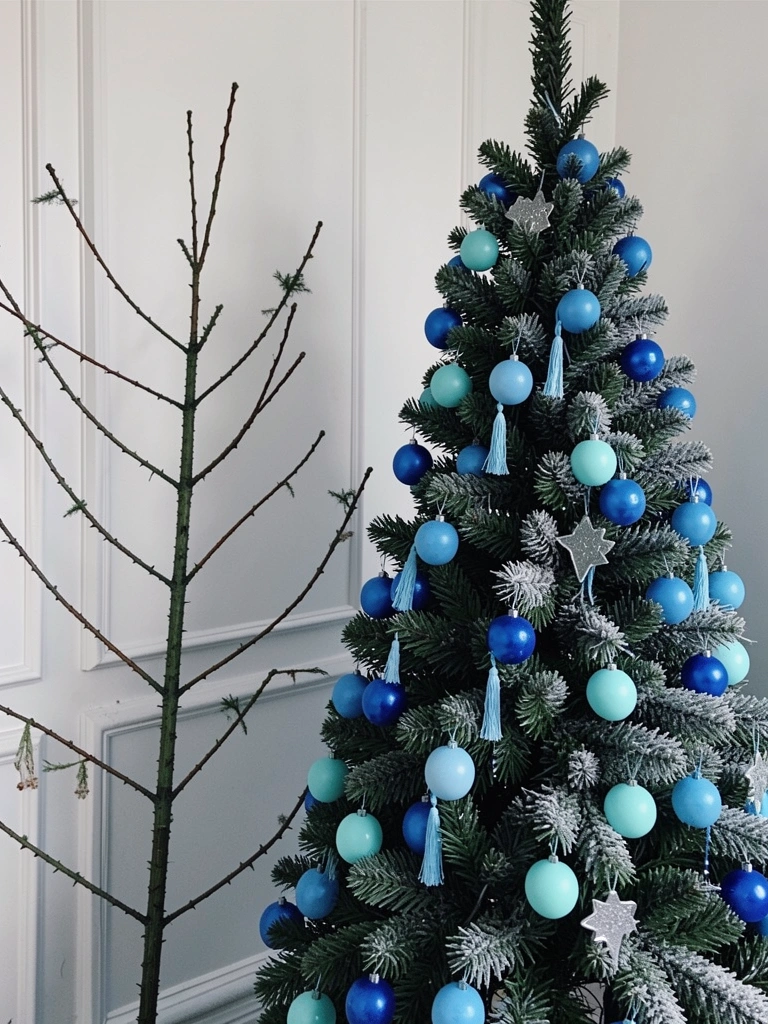 Árvore de natal fina ao lado de uma árvore cheia, ambas decoradas em azul e branco